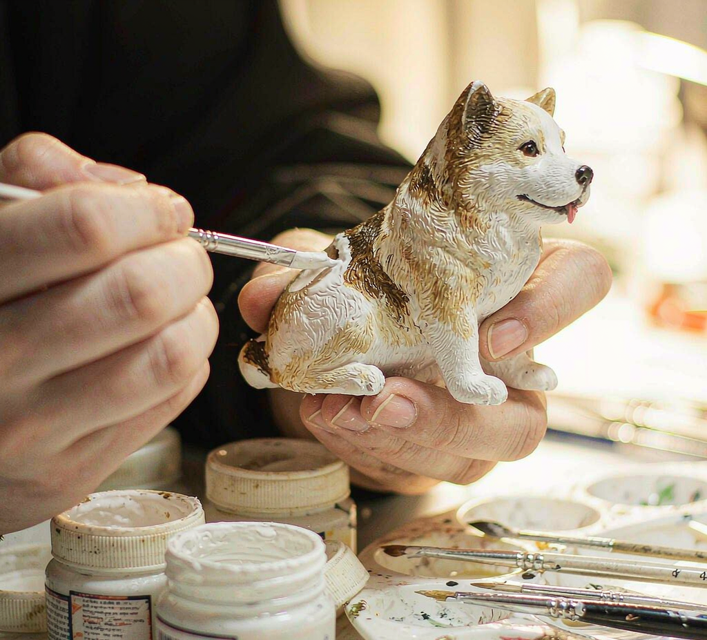 Studio sample: an artist hand-painting fur detail onto a resin figurine